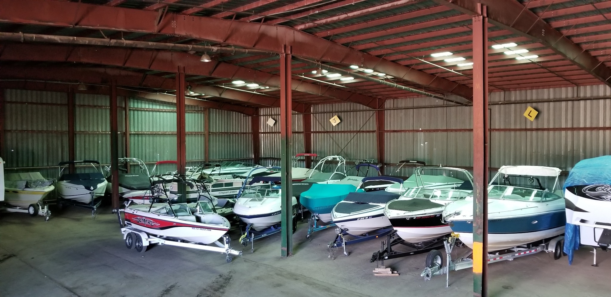 Boats and trailers stored inside the secure Save Money Tahoe Boat Storage building